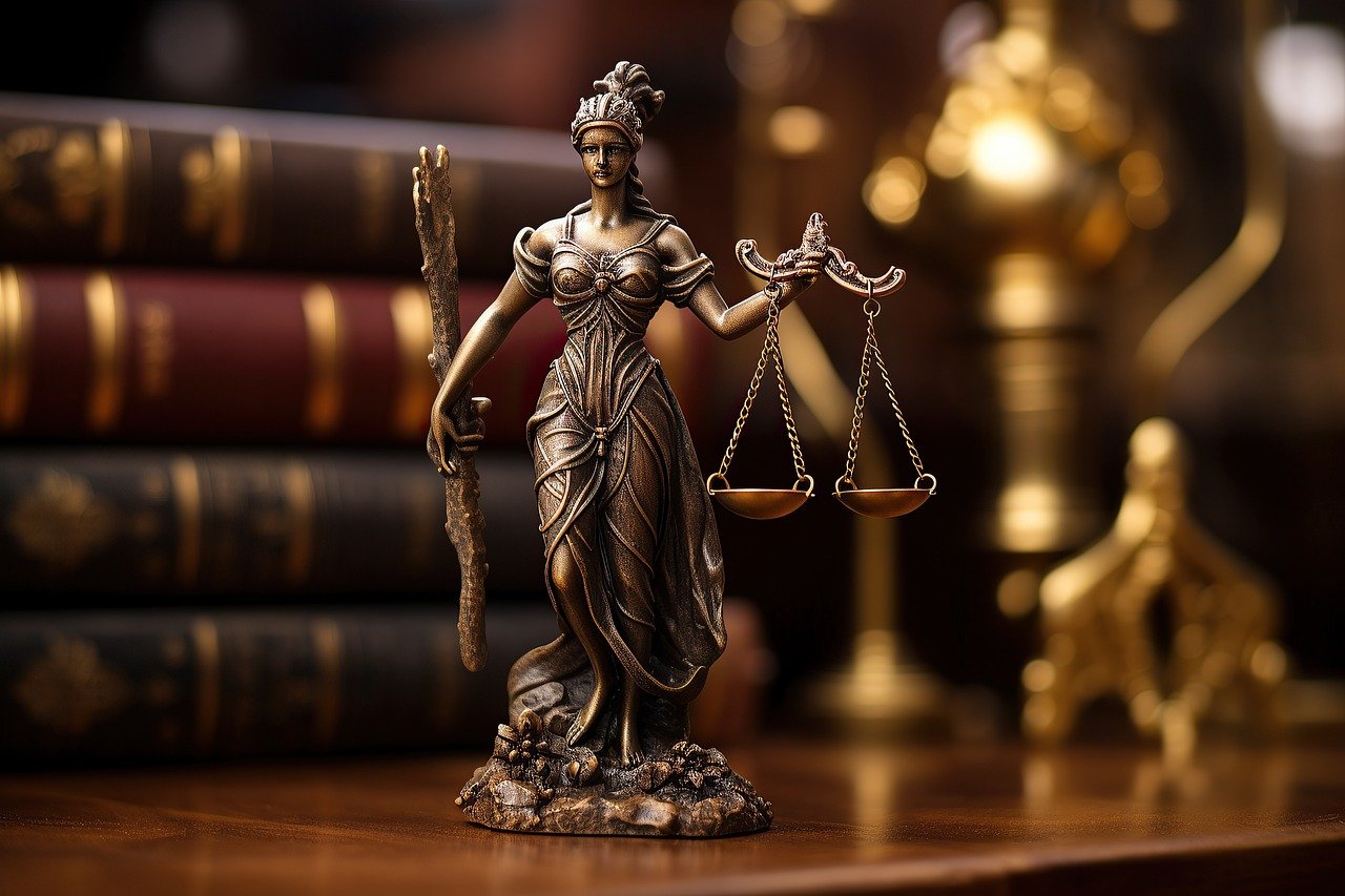 Justice statue and law books on a desk